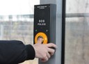 Detail SOS tlačítka. Je na něm varování: Zneužití tísňové linky je trestné.
